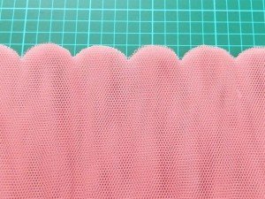 Scalloped edge on dyed net